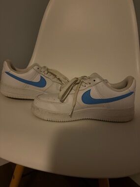 Nike White Low-Top Sneakers with Sky Blue Swoosh